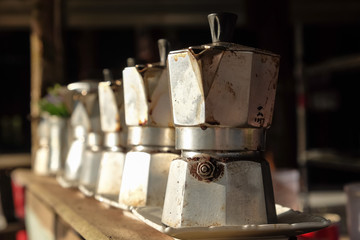 Close up coffee pot old aluminum open breakfast morning market on stove with sunlight