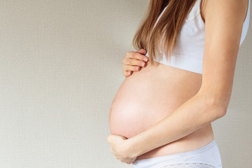 Fototapeta na wymiar Belly of a pregnant woman 7 month closeup