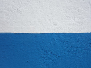 Wall background painted half blue and half white.
