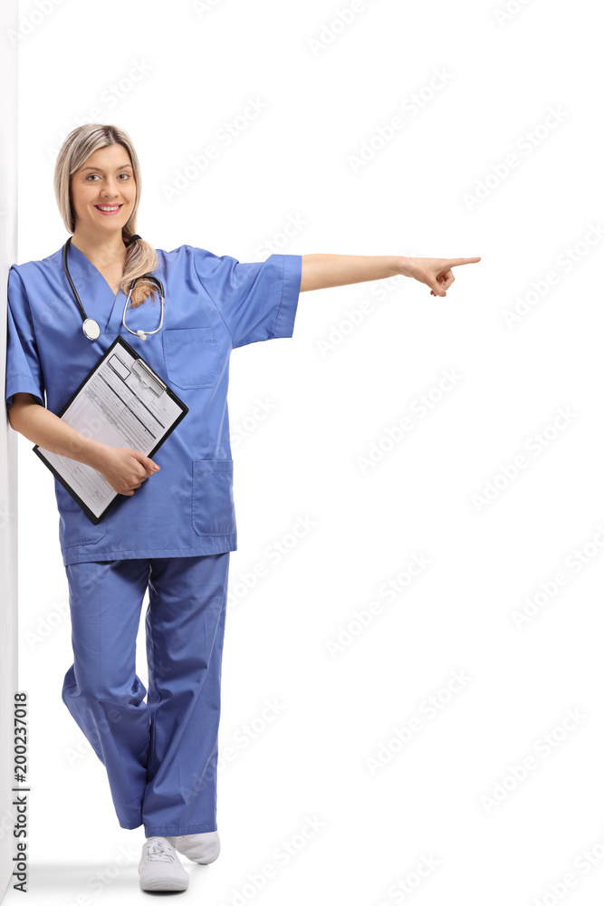 Poster female doctor with a clipboard leaning against a wall and pointing