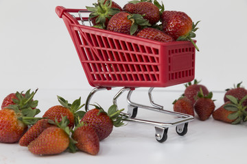 Strawberries in Shopping Cart, Isolated on White Background. Buying a strawberries from supermarket.