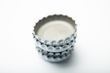 White caps from beer bottles on a white background.