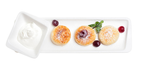 Cheese pancakes isolated top view. Cottage cheese pancakes with sour cream and cherry