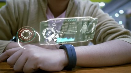 Close up shot hands of woman using smart watch with HUD user interface for cyber futuristic application and technology concept - Powered by Adobe