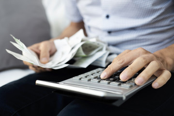 young man with bills and calculator