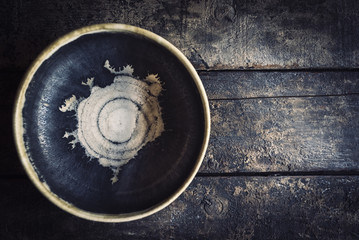 Craft maded empty plate on the wooden background with blank space