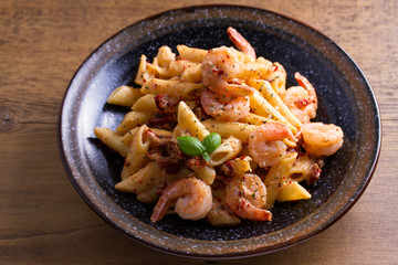 Shrimp pasta with sun dried tomatoes and basil in creamy mozzarella sauce