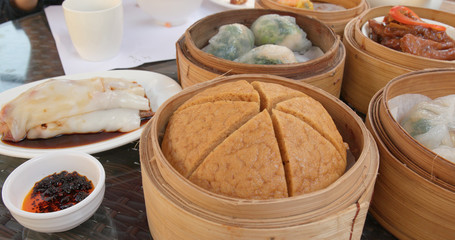 Eating Chinese dim sum in restaurant