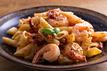 Shrimp pasta with sun dried tomatoes and basil in creamy mozzarella sauce