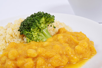 Roman peas with pumpkin and bulgur on a white