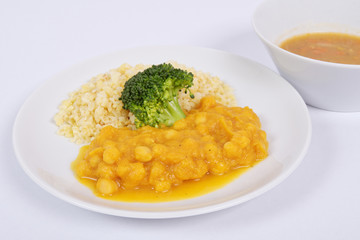 Roman peas with pumpkin and bulgur on a white