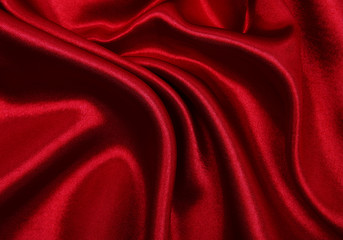 Smooth elegant red silk or satin luxury cloth texture as abstract background. Luxurious valentines day background design