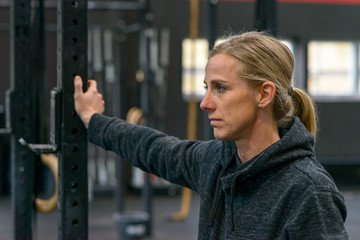 Thoughtful woman in a track suit at a gym