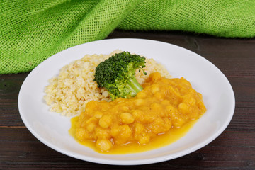 Roman peas with pumpkin and bulgur on a table
