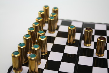 Blind and gas bullets on chessboard like black and white chess pieces