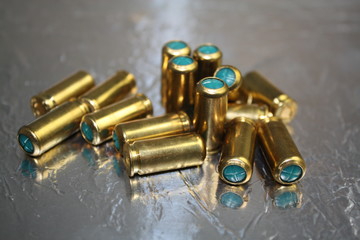 Obraz na płótnie Canvas Close up group of blind bullet munition on silver shiny surface desk