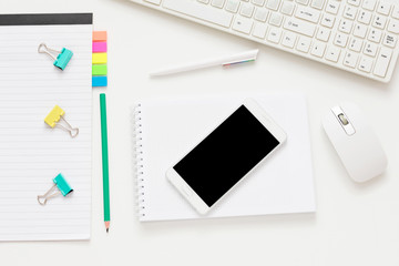 white Desk, smart phone, lying on the table, white background with copy space, for advertisement, top view