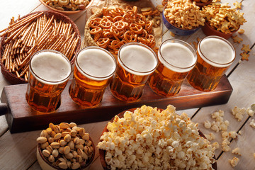 Lager beer and snacks on wooden table with copy space