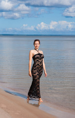 Fototapeta premium Young elegant woman in black lace dress