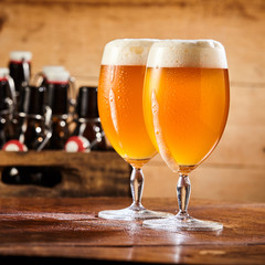 Two chalices of fresh cold pale beer with foam