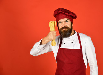 Fototapeta na wymiar Italian cuisine concept. Man or hipster with beard holds macaroni
