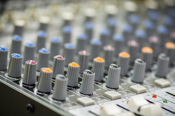 Fototapeta premium Close up of a mixing console with sliders and buttons.