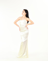 Health and body care concept. Woman in elegant white dress, white background. Fashion model with slim figure as result of dieting and fitness. Lady on dreamy face enjoy her sporty figure, shapes.