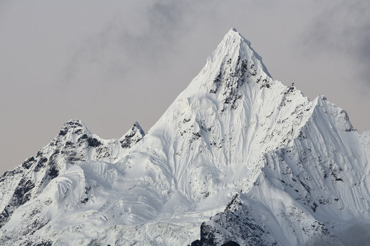 View of Meili Snow Mountain against cloudy sky