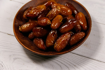 Dried dates fruit on white wooden table