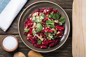 beet salad on a wooden table, apple, coriander, walnut, Jewish cuisine, Jewish New Year, Rosh...