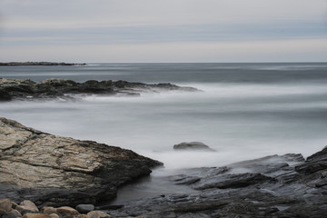 Fototapeta na wymiar Ocean Waves Over Rocks at Cliff Walk in Rhode Island