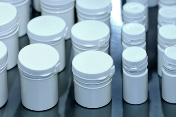 White plastic jars for medical tablets and pills