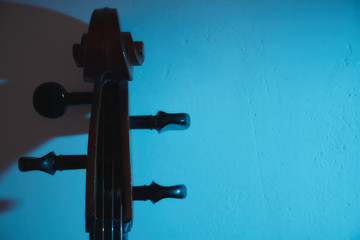Cello in dark room with club light