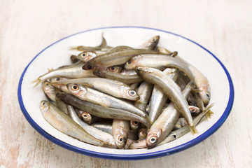 small fish in white plate © Natalia Mylova