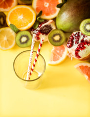 various fruits and a glass with a straw