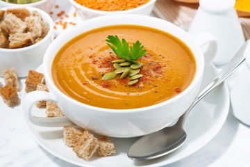 soup of pumpkin and lentils in a bowl, closeup