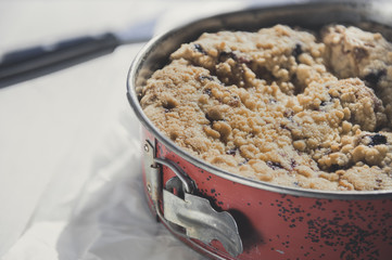 Coffee cake in a tin pan on white wooden table. Horizontal.