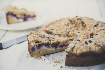 Tasty berries coffee cake on white wooden table. Horizontal.