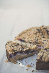 Tasty berries coffee cake on white wooden table. Vertical. Copy space. 