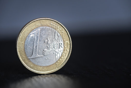 One euro coin on black background