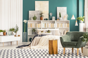 Green bedroom interior with armchair