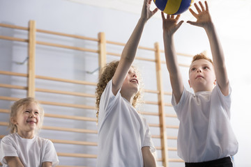 Happy boys playing volleyball