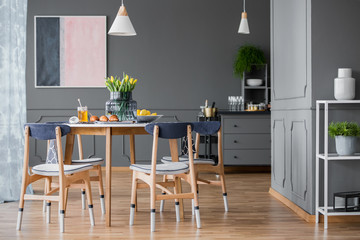 Paint dipped chairs around table
