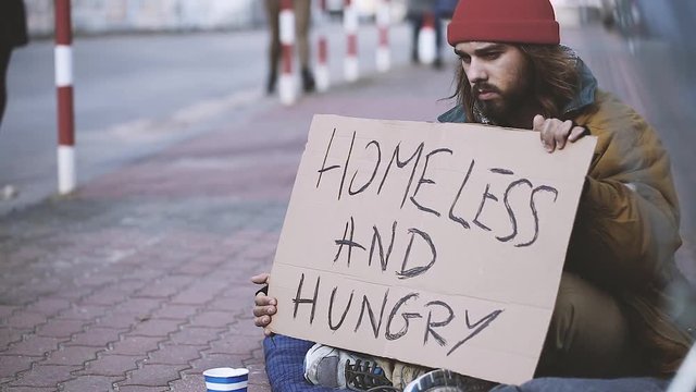 Video of dirty man asking for food and money on the sidewalk because he is hungry and homeless