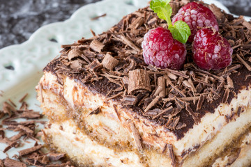 Homemade Tiramisu Cake Dessert with Grated Chocolate, Raspberry and Mint
