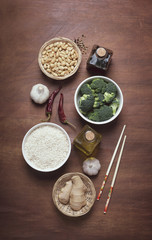 Fototapeta na wymiar Chinese food raw ingredients, vegetables and nuts on the rustic wooden background