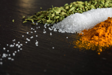 spices of turmeric, fennel and sea salt on the stone surface are large