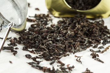 Traditional Chinese  black tea and brew sieve on wooden table