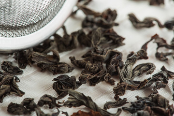 Chinese  black tea and brew sieve very close-up