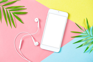 Mobile phone headphones summer holidays flat lay background